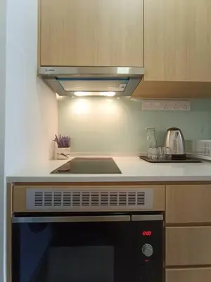 a kitchen with a stove and a microwave at COL 18A Modern Balcony KLCC View Infinity Pool in Kuala Lumpur