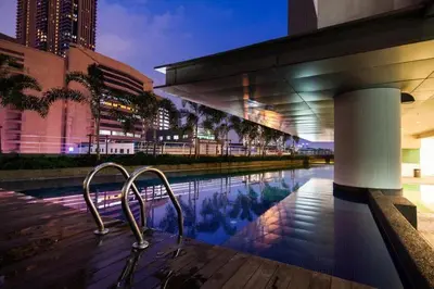 a swimming pool in front of a building at Taragon Bukit Bintang in Kuala Lumpur