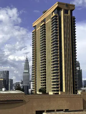 a large tall building in front of a city at Taragon Bukit Bintang in Kuala Lumpur