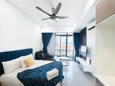a bedroom with a bed and a ceiling fan at Taragon Bukit Bintang in Kuala Lumpur