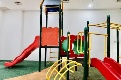 a play room with a playground with a slide at Taragon Bukit Bintang in Kuala Lumpur