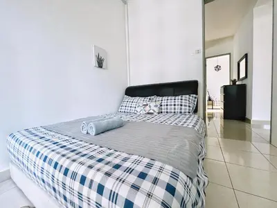 a bedroom with a bed with a blue and white blanket at Rafflesia KL Big Family 3BR Condo Near LRT in Kuala Lumpur