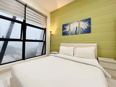 a bedroom with a large white bed and a window at Arte mont kiara by Happy stay in Kuala Lumpur