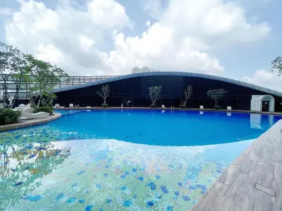 a large swimming pool in front of a building at Arte mont kiara by Happy stay in Kuala Lumpur