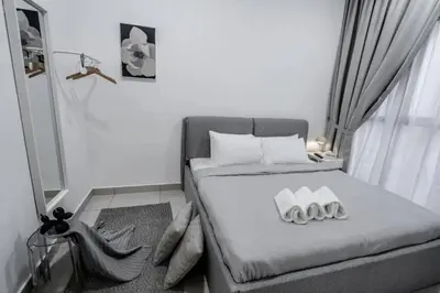 a small bedroom with a bed with two pillows at Trion KL - 2 Bedroom, 5 pax, Netflix, Free Car Park in Kuala Lumpur