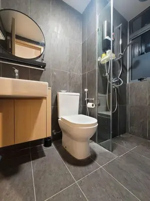 a bathroom with a toilet and a sink and a mirror at COL 14A Modern Infinity Pool KLCC View with Balcony in Kuala Lumpur