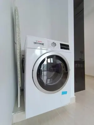 a white washing machine sitting in a room at LUX 39A Balcony KLCC View 1 Bedroom Infinity Pool in Kuala Lumpur