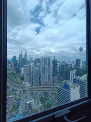 a view of a city skyline from a window at LUX 39A Balcony KLCC View 1 Bedroom Infinity Pool in Kuala Lumpur