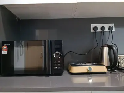a microwave sitting on top of a kitchen counter at LUX 39B KLCC view Studio in Kuala Lumpur