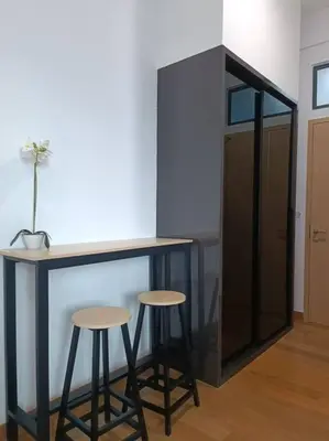 a bar with two stools in a room with a counter at LUX 39B KLCC view Studio in Kuala Lumpur