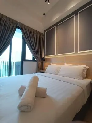 a bedroom with a large white bed with a towel on it at COL 27A KLCC View Infinity Pool View in Kuala Lumpur