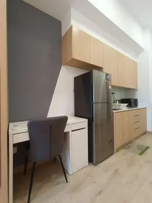 a small kitchen with a desk and a refrigerator at COL 27A KLCC View Infinity Pool View in Kuala Lumpur