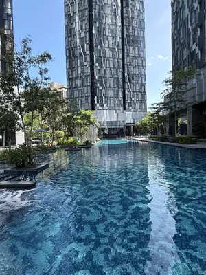 a large pool of water with two tall buildings at Star Serviced Suite KLCC in Kuala Lumpur