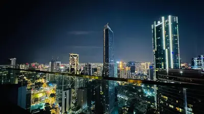 a city skyline at night with tall buildings at Star Serviced Suite KLCC in Kuala Lumpur