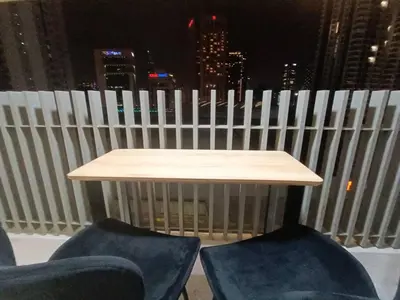 a table and chairs with a view of the city at COL 915A Modern Duplex Studio KLCC in Kuala Lumpur