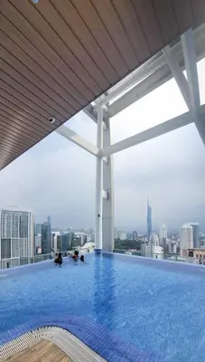 a swimming pool on top of a building with a city skyline at COL 915B Studio Balcony Infinity Pool KLCC View in Kuala Lumpur