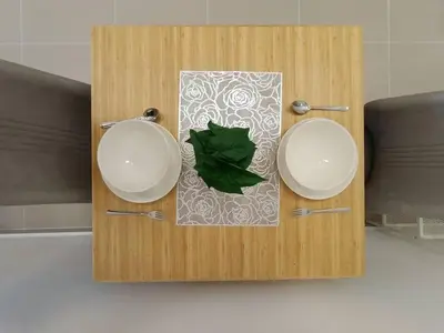 a wooden table with two plates and a green leaf at COL 29A Cozy KLCC View & Infinity Pool in Kuala Lumpur
