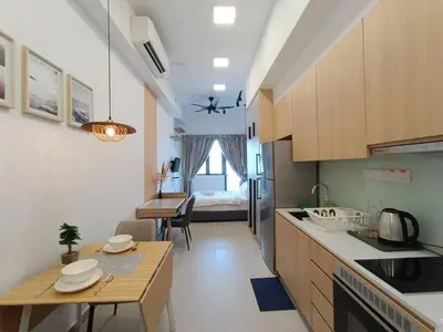 a kitchen with a table and a room with a bed at COL 29A Cozy KLCC View & Infinity Pool in Kuala Lumpur