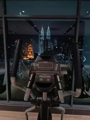 a camera in front of a window with a city at COL 30B KL Tower View Cozy Studio in Kuala Lumpur