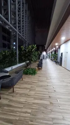 a hallway with benches and plants in a building at COL 30B KL Tower View Cozy Studio in Kuala Lumpur