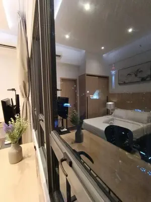 a hotel room with a bed and a mirror at COL 30B KL Tower View Cozy Studio in Kuala Lumpur