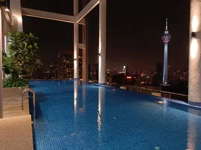 a swimming pool on the roof of a building with a city skyline at COL 31A 1Bedroom Balcony Infinity Pool KLCC View in Kuala Lumpur