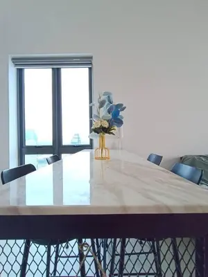a dining room table with a vase of flowers on it at COL 31A 1Bedroom Balcony Infinity Pool KLCC View in Kuala Lumpur