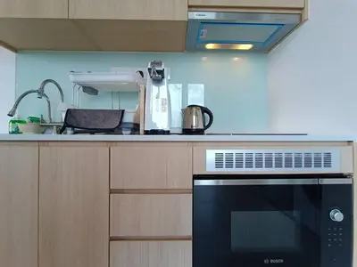 a kitchen with a black oven and a sink at COL 31A 1Bedroom Balcony Infinity Pool KLCC View in Kuala Lumpur