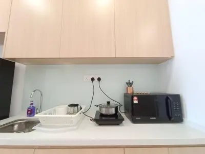 a kitchen counter with a microwave and a sink at COL 23aA Cozy KLCC View & Infinity Pool Studio in Kuala Lumpur