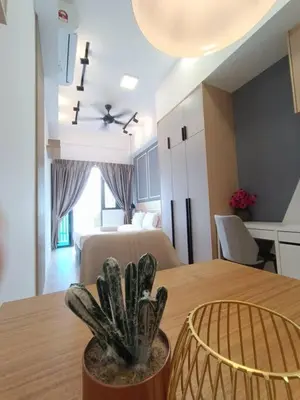 a room with a table with a plant on it at COL 23aA Cozy KLCC View & Infinity Pool Studio in Kuala Lumpur