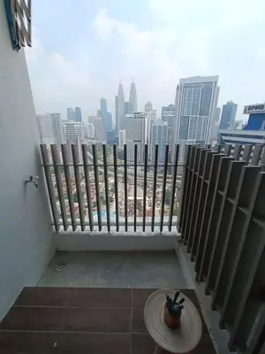 a balcony with a view of a city skyline at COL 23aB Cozy KLCC View & Infinity Pool Studio in Kuala Lumpur