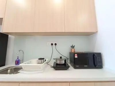 a kitchen counter with a microwave and a sink at COL 23aB Cozy KLCC View & Infinity Pool Studio in Kuala Lumpur