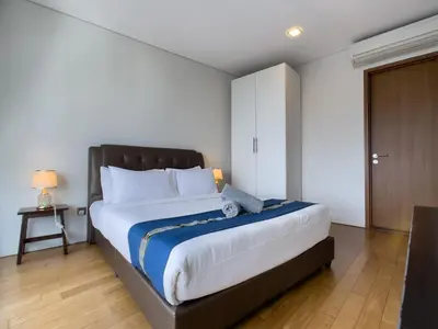 a bedroom with a large bed and a table at Vortex Suites klcc By Sayang in Kuala Lumpur