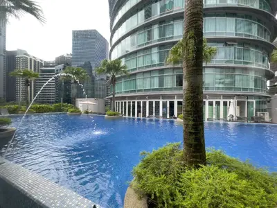 a large swimming pool in front of a tall building at Vortex Suites klcc By Sayang in Kuala Lumpur