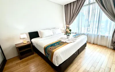 a bedroom with a large bed and a large window at Vortex Suites klcc By Sayang in Kuala Lumpur