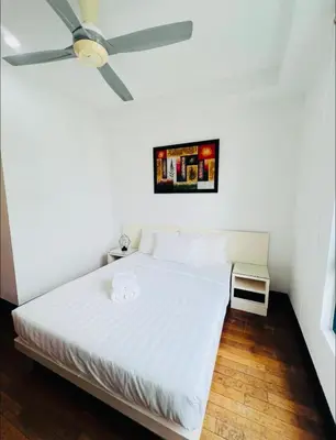 a bedroom with a white bed with a ceiling fan at KL Homestay at Casa Residency- Walk to Lalaport & LRT in Kuala Lumpur