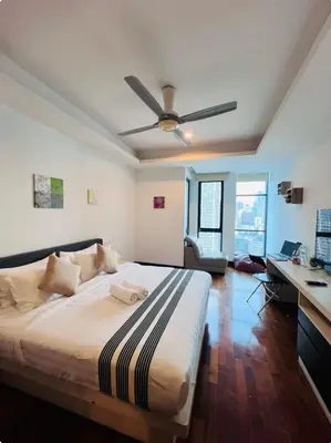 a bedroom with a bed with a ceiling fan at KL Homestay at Casa Residency- Walk to Lalaport & LRT in Kuala Lumpur
