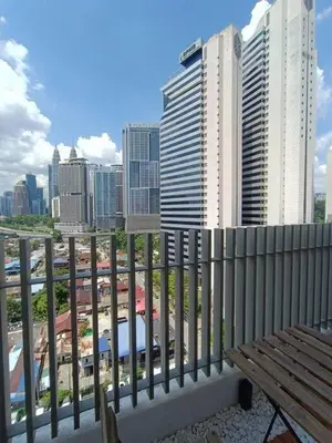 a bench on a balcony with a view of a city at COL 93A 2Queen bed Balcony KLCC View Family Suites in Kuala Lumpur