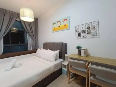 a bedroom with a bed and a desk and a table at COL 93B Balcony KLCC View & Infinity Pool Studio in Kuala Lumpur