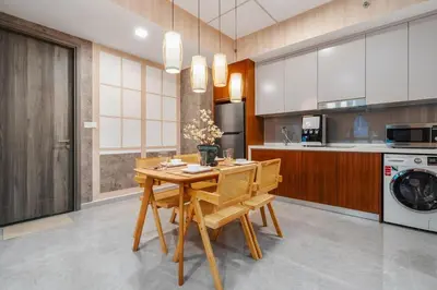a kitchen with a wooden dining room table and chairs at Japandi 1BR Agile Bukit Bintang by RumaBnB in Kuala Lumpur