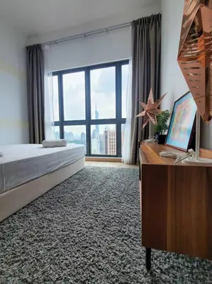 a bedroom with a bed and a desk and a window at COL25A KL Tower Balcony 1Bedroom & Infinity Pool KLCC View in Kuala Lumpur