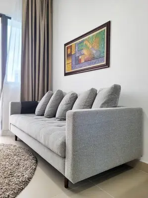 a couch in a living room with a picture on the wall at COL25A KL Tower Balcony 1Bedroom & Infinity Pool KLCC View in Kuala Lumpur