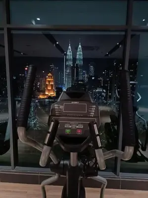 a camera in front of a window with a city at COL 25B KLCC Infinity Pool View Studio in Kuala Lumpur