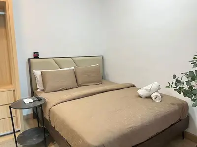 a bed with a teddy bear sitting on top of it at COL 25B KLCC Infinity Pool View Studio in Kuala Lumpur