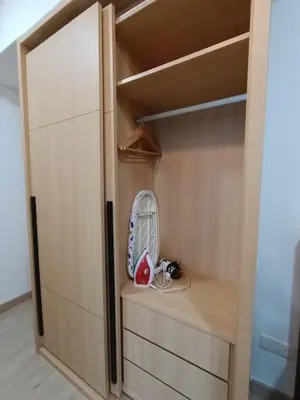 a closet with a fan sitting on a wooden shelf at COL 25B KLCC Infinity Pool View Studio in Kuala Lumpur