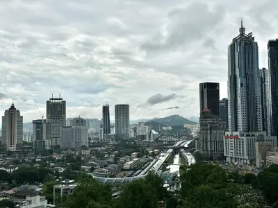 a city with tall buildings and a highway in the foreground at Hushed Dorm KL in Kuala Lumpur