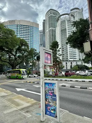 a sign on the side of a city street with buildings at Hushed Dorm KL in Kuala Lumpur