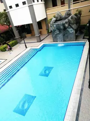 a large swimming pool with blue water in front of a building at Kuala Lumpur Homestay Bandar Sri Permaisuri in Kuala Lumpur