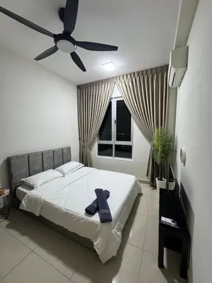 a bedroom with a bed and a ceiling fan at Studio Stay in Kuala Lumpur