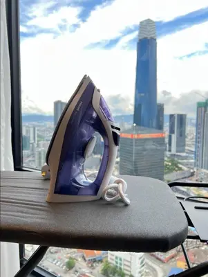 a iron sitting on top of a table in a window at KL Suites Axon Residence - Wi-Fi 500Mbph in Kuala Lumpur